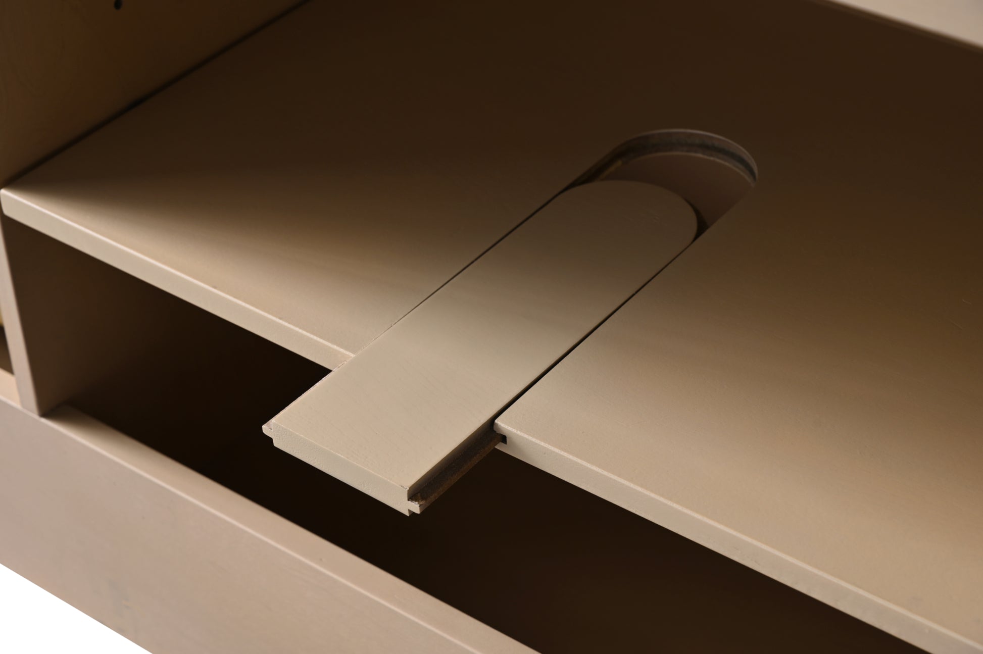 Close-up of integrated power outlet panel inside light oak bathroom vanity cabinet interior