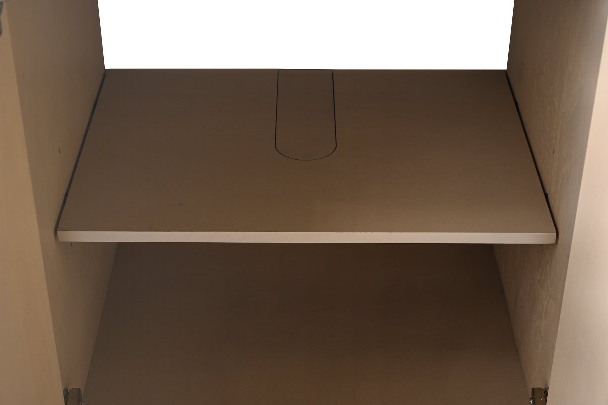 Interior fixed shelf with cord management slot inside center cabinet of light oak bathroom vanity