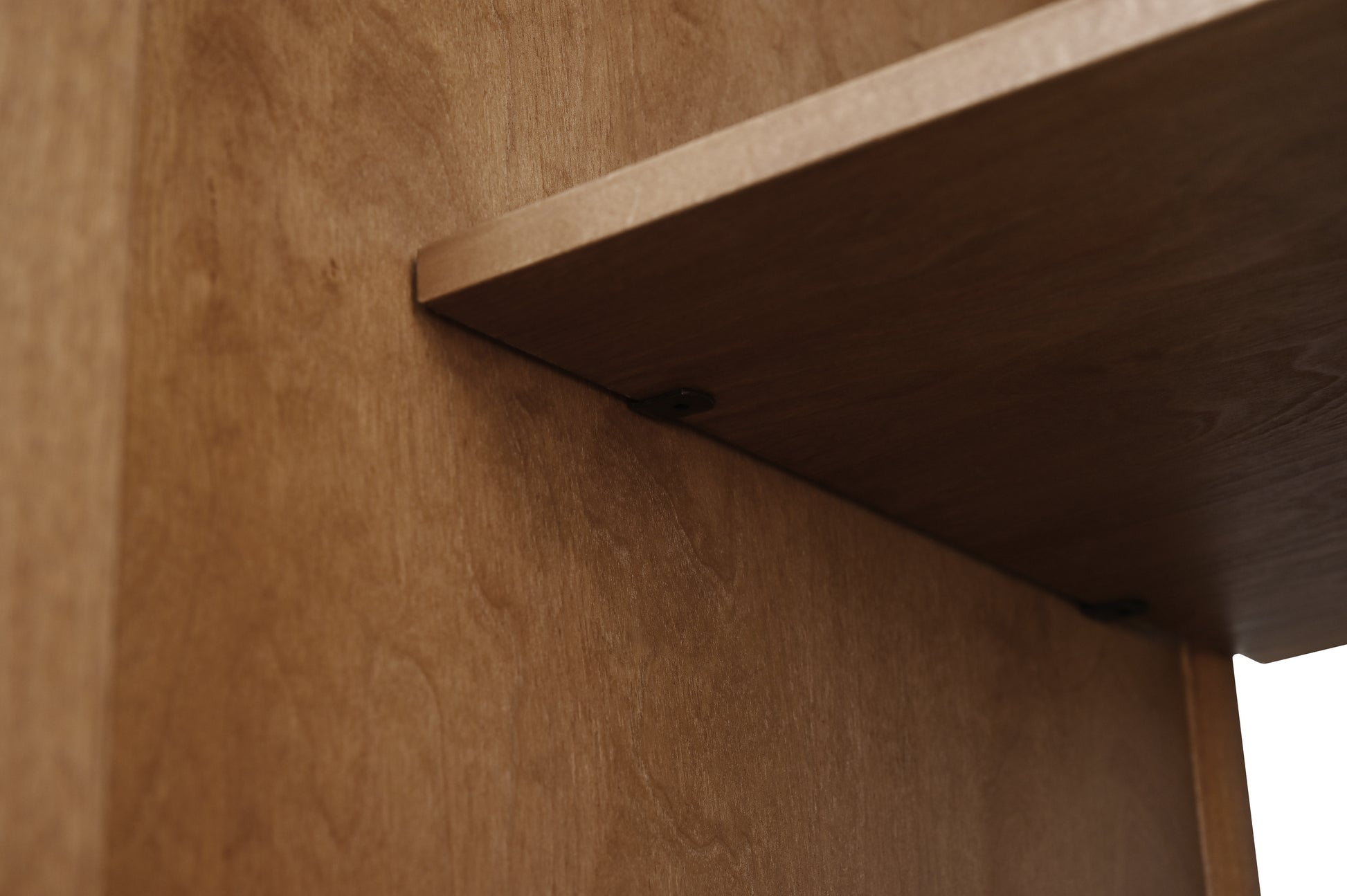 Close-up of walnut wood grain shelf detail on 72-inch bathroom vanity cabinet interior
