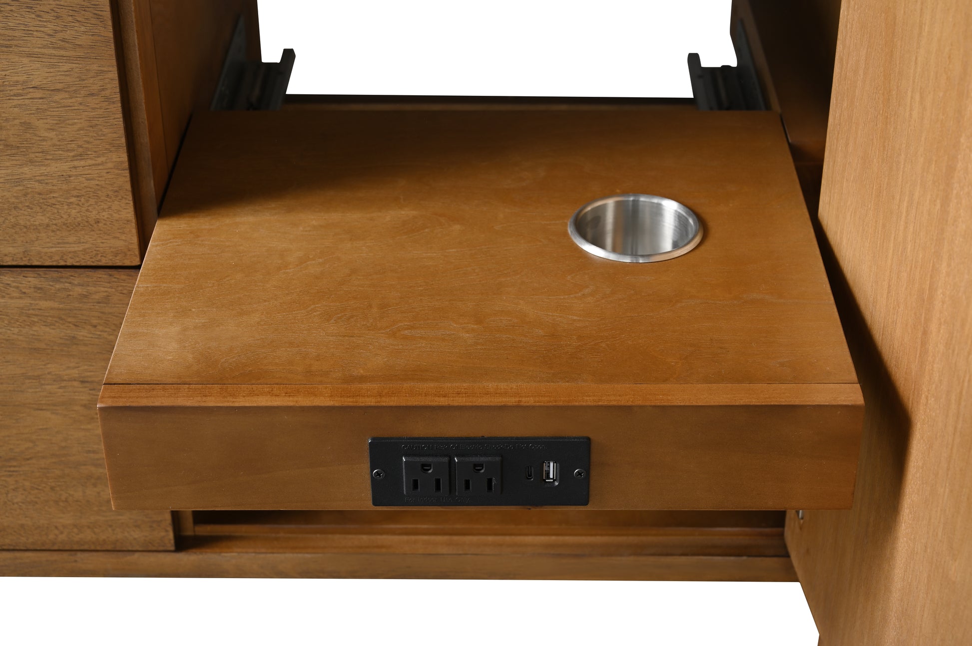 Close-up of vanity interior pull-out shelf with duplex outlet, USB port, and metal grommet cutout