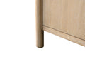 Close-up of light oak vanity cabinet leg showing rounded cylindrical wood detail and natural grain finish