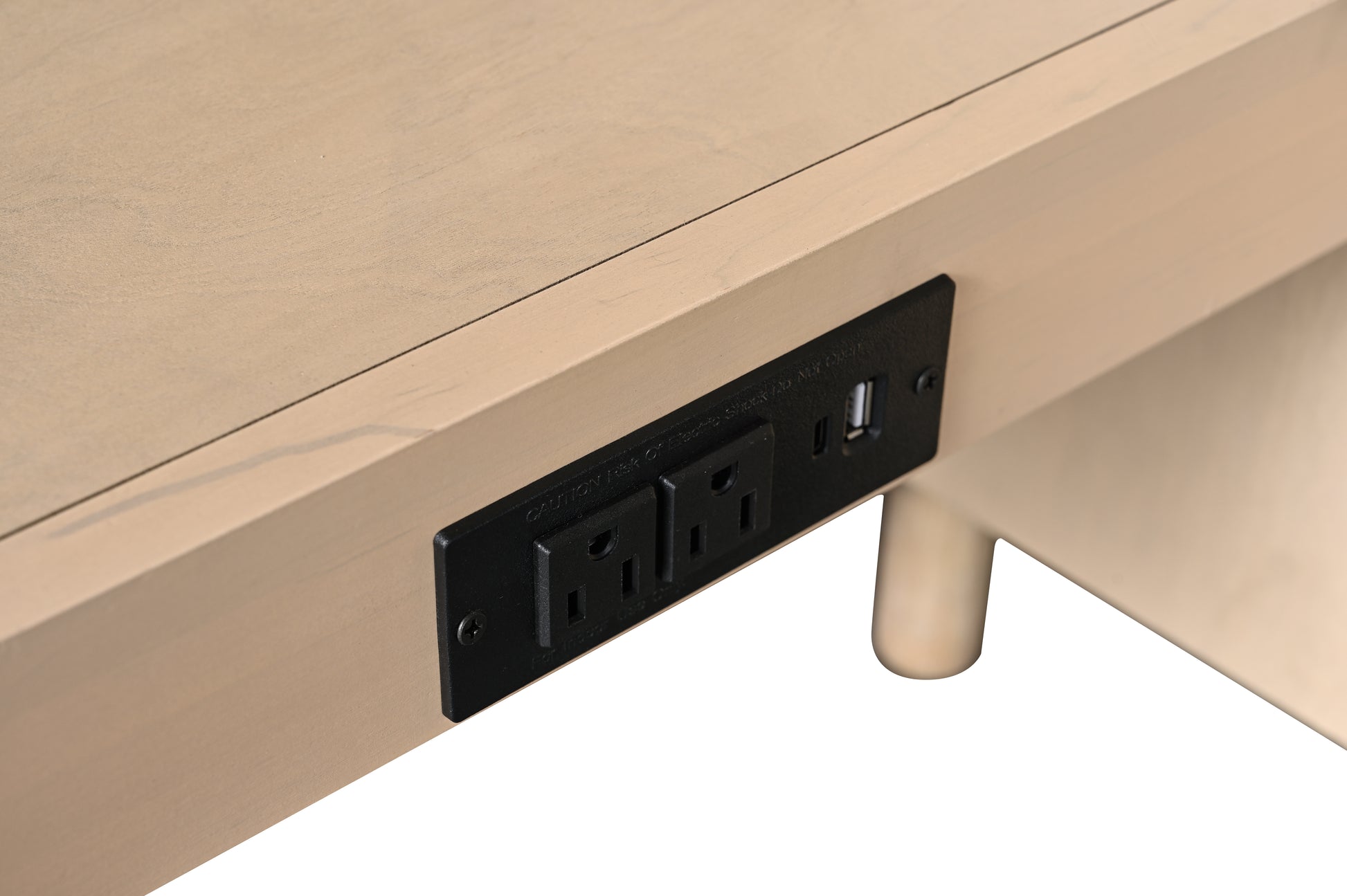 Close-up of built-in black power strip with two AC outlets and USB port on underside of vanity shelf