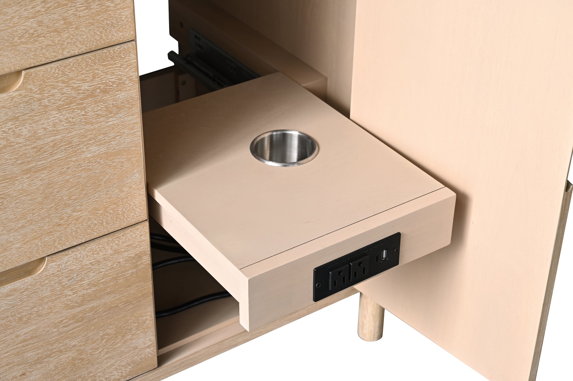 Close-up of pull-out shelf inside oak vanity cabinet with power strip, USB charging port, and hairdryer holder