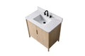Top-down angled view of 36-inch light oak bathroom vanity with closed doors and white Carrara stone top, black faucet
